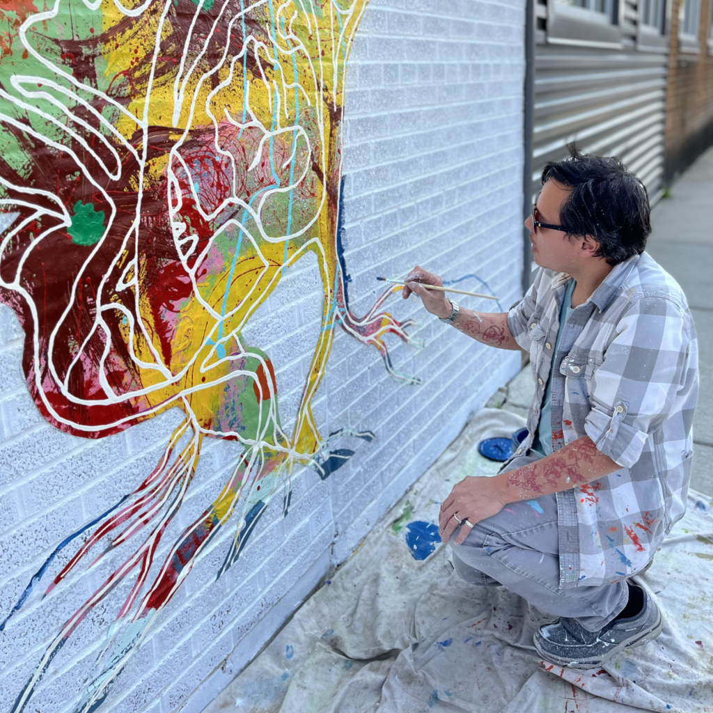 Richie Morales begins work on the Regenerative Coexistence mural at the State Line Distillery